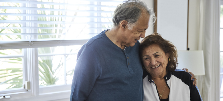Man and woman in a living room embracing each other