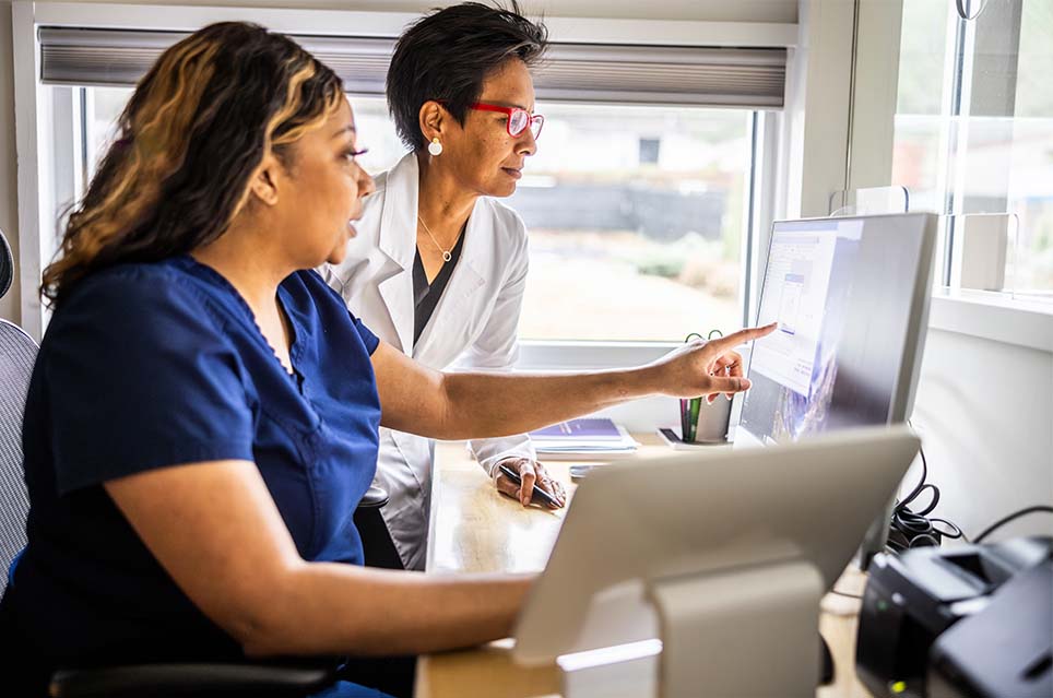 healthcare providers pointing at computer