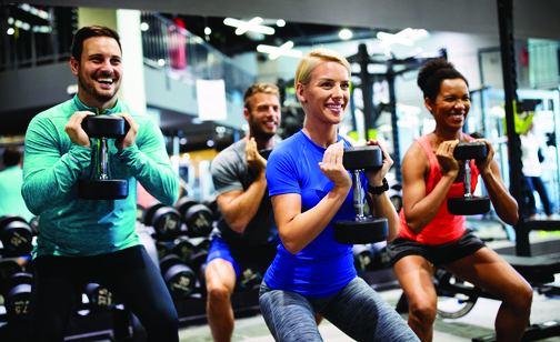 group of adults lifting weights together