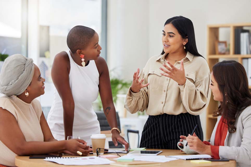 4 women discussing in meeting