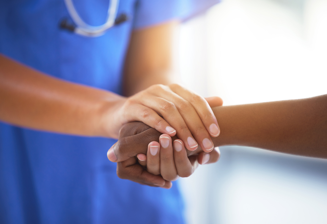 nurse holding hospital patient's hand