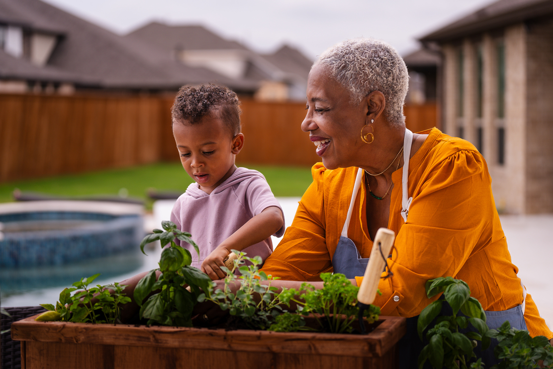 grandmother gardening with young grandson