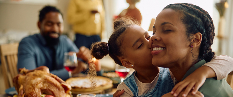 daughter kissing mother