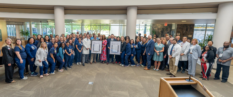 A large group of Sentara Norfolk General Hospital staff, leaders, and Virginia legislators gather in the hospital lobby to mark the ceremonial signing of the Protecting Healthcare Workers Act, Thursday, June 4, 2026.