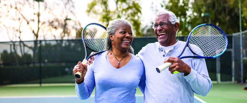 senior couple playing tennis