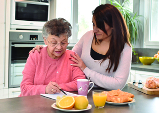 woman standing with elder woman in the kitchen 