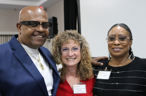 Stroke survivor Larry Robinson, Sentara Northern Virginia Medical Center clinical manager Andrea Helmbach, and Angela Robinson smile together at the 6th Annual Sentara Stroke Symposium in Williamsburg, Virginia.