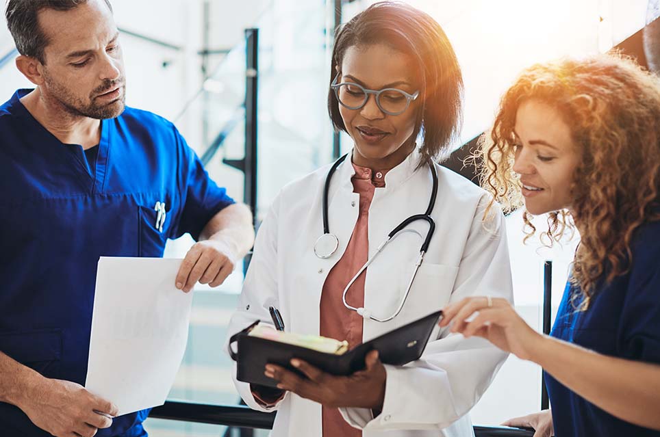 doctor and two nurses looking at notes