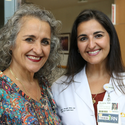 Mirna Medina-Gonzalez (left) and her daughter, Maxine Morales, smile together at Sentara Norfolk General Hospital, where both have built careers in nursing.