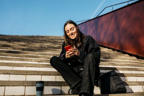 young-woman-outside- looking-at-phone.jpg