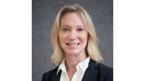 Professional headshot of Nancy Bagranoff, wearing a black blazer and white shirt, smiling against a gray background.