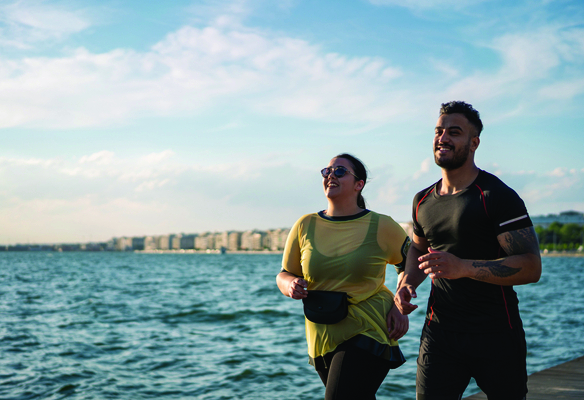 woman running with her trainer