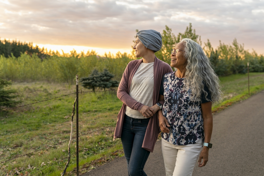 Mom and daughter walking by sunset