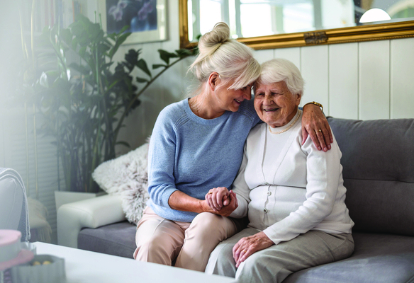 middle aged woman and elderly woman on couch