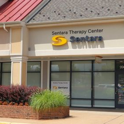 Exterior of the new Sentara Therapy Center in Manassas, Virginia, located on Liberia Avenue. The Sentara Therapy Center sign is displayed above the entrance to the rehabilitation facility.