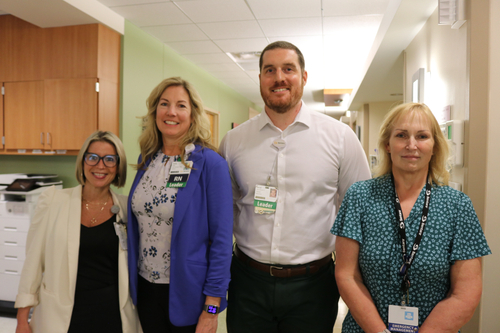 Four Sentara Princess Anne Hospital leaders smile for a photo inside the hospital's specialized infectious disease isolation unit.