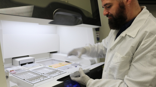 Sentara Clinical Lab Coordinator Luke Grissom removes tissue samples in the Sentara Molecular Diagnostics Laboratory.JPG