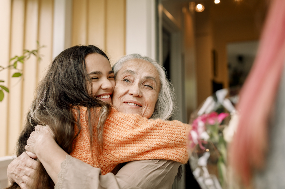 granddaughter hugging grandmother