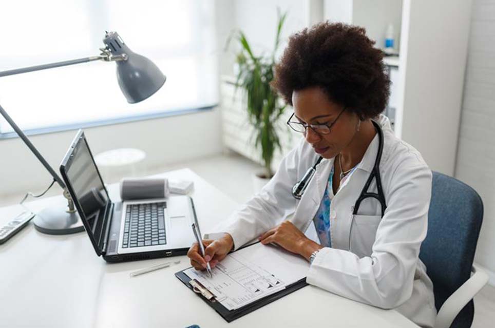 provider reviewing charts on clipboard