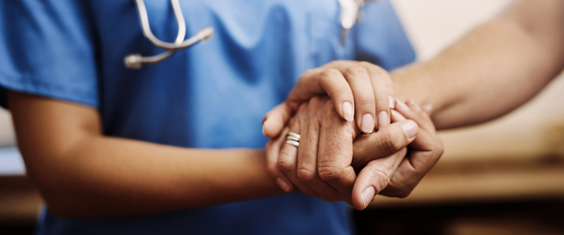 nurse holding a patient's hand