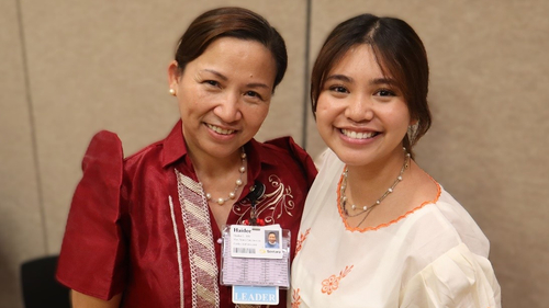 Haidee Lavina (left) and her daughter, Nicole Lavina, smile while standing together and posing for a photo at Sentara Northern Virginia Medical Center, where they both have built nursing careers.