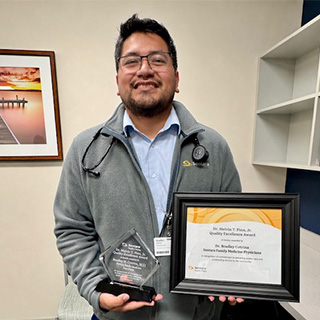 Dr. Bradley Cotrina, the 2026 Dr. Melvin T. Pinn, Jr. Quality Excellence Award recipient, holding his award