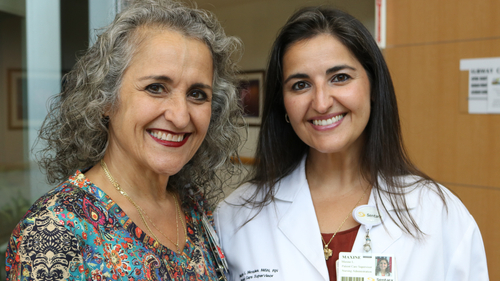 Mirna Medina-Gonzalez (left) and her daughter, Maxine Morales, smile together at Sentara Norfolk General Hospital, where both have built careers in nursing.