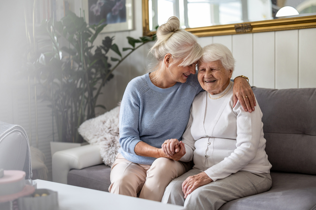 middle aged woman and elderly woman on couch