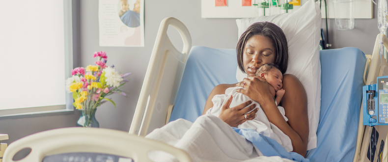 mom and newborn in hospital bed