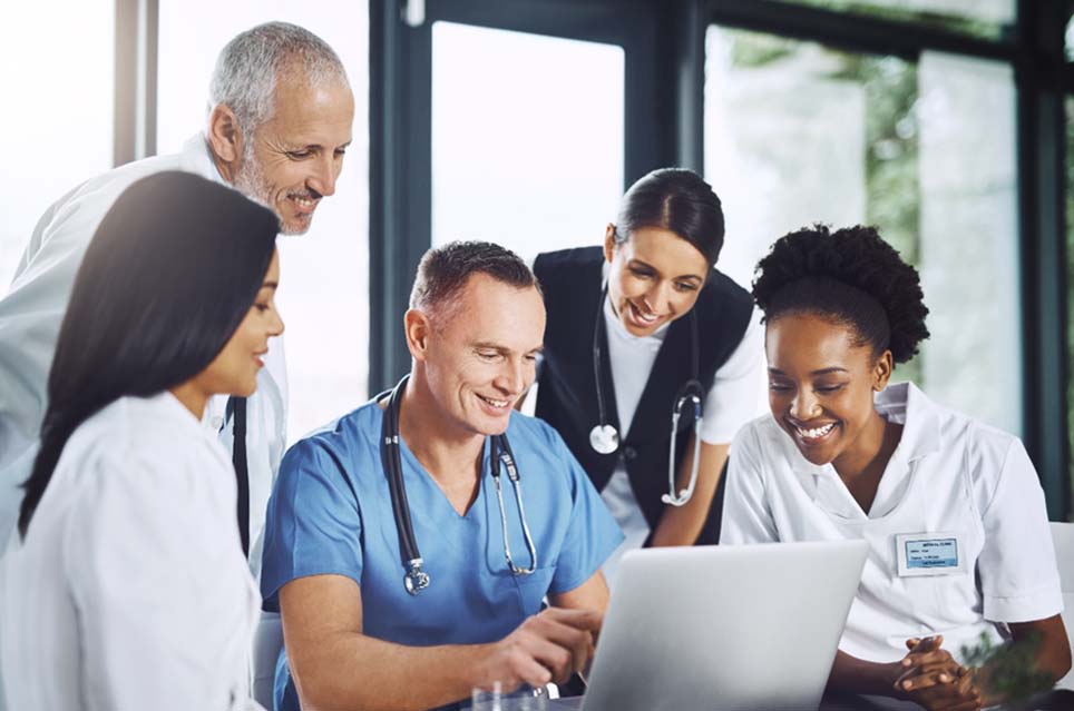 doctors around computer