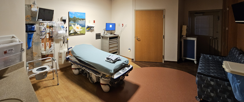 Interior of the specialized infectious disease isolation room at Sentara Princess Anne Hospital, featuring a patient bed, medical equipment, and a separate entrance door.