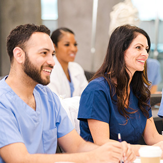 Group in scrubs learning clinical