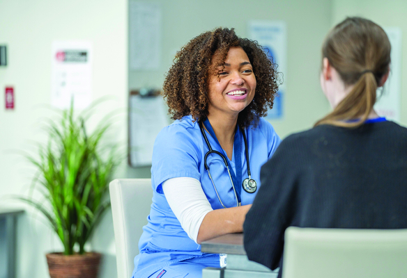 happy nurse talking to patient