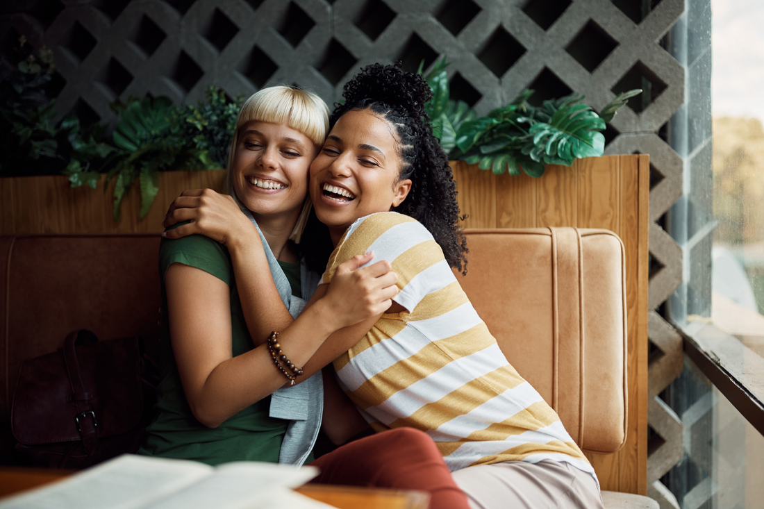 friends hugging in restaurant