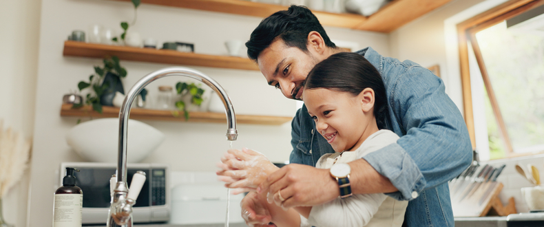 father and daughter washing hands