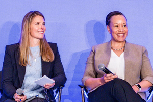 Joanne Inman and Dana Weston Graves smile on stage at a Sentara leadership retreat