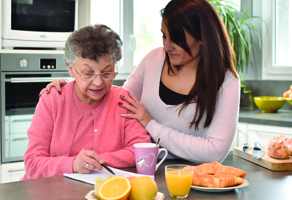 woman and elder woman in the kitchen with breakfast
