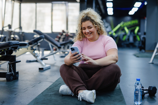 Woman on phone in gym.jpg