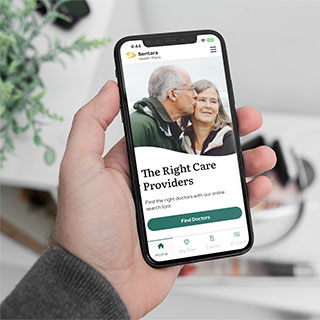 hand holding phone with Sentarahealthplans.com home page visible