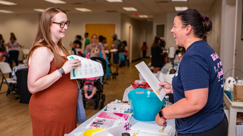 An expecting mother receives support at a Sentara Health Plans Baby Shower