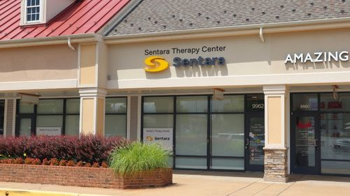 Exterior of the new Sentara Therapy Center in Manassas, Virginia, located on Liberia Avenue. The Sentara Therapy Center sign is displayed above the entrance to the rehabilitation facility.