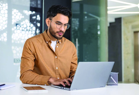 man typing on computer in office