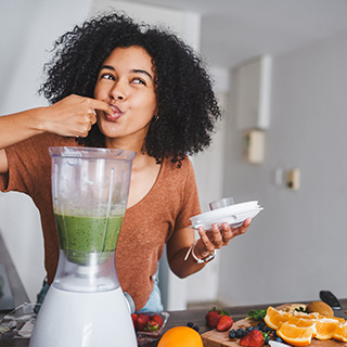 woman tasting green smoothie.jpg