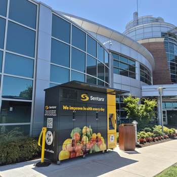A Sentara-branded refrigerated food locker stands outside the emergency department entrance of Sentara Obici Hospital in Suffolk, Virginia, available around the clock to provide fresh food to patients and community residents in need.