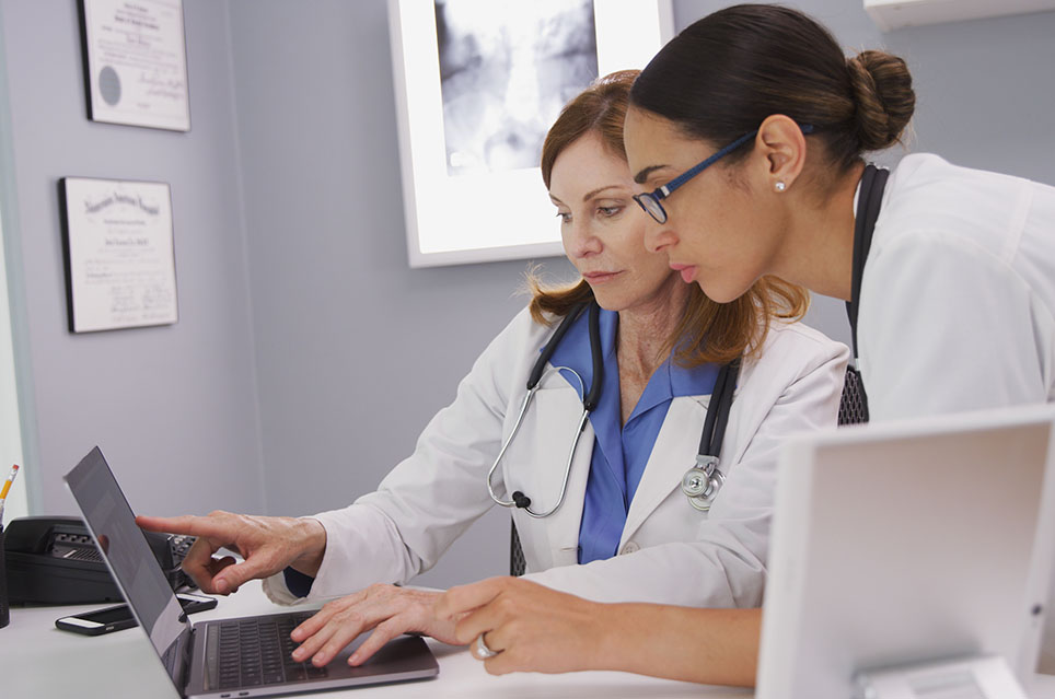 2 Doctors Looking at Computer