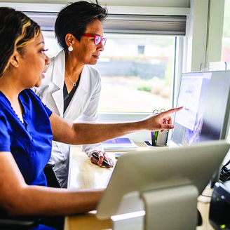healthcare providers pointing at computer