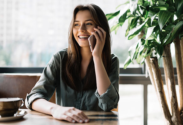 Woman at the table talking on phone