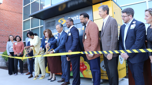 Sentara Obici Hospital and Suffolk Christian Fellowship Center leaders cut the ribbon on a new community food locker outside the hospital's emergency department entrance in Suffolk, Virginia.
