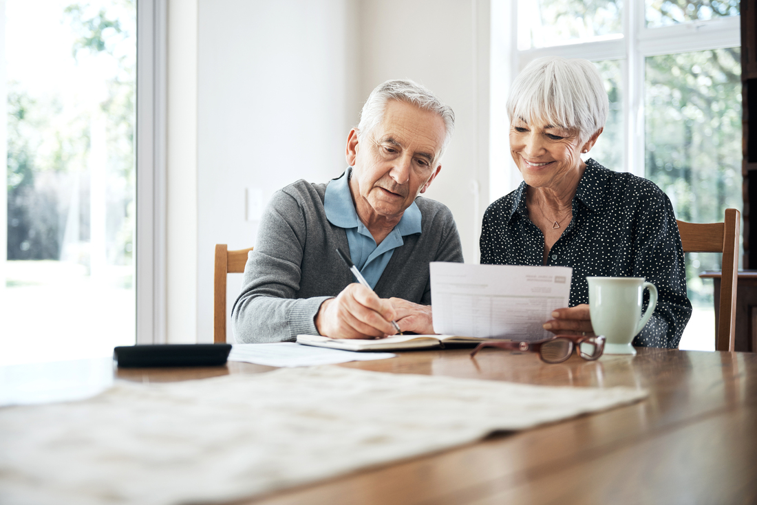 older couple filling out paperwork
