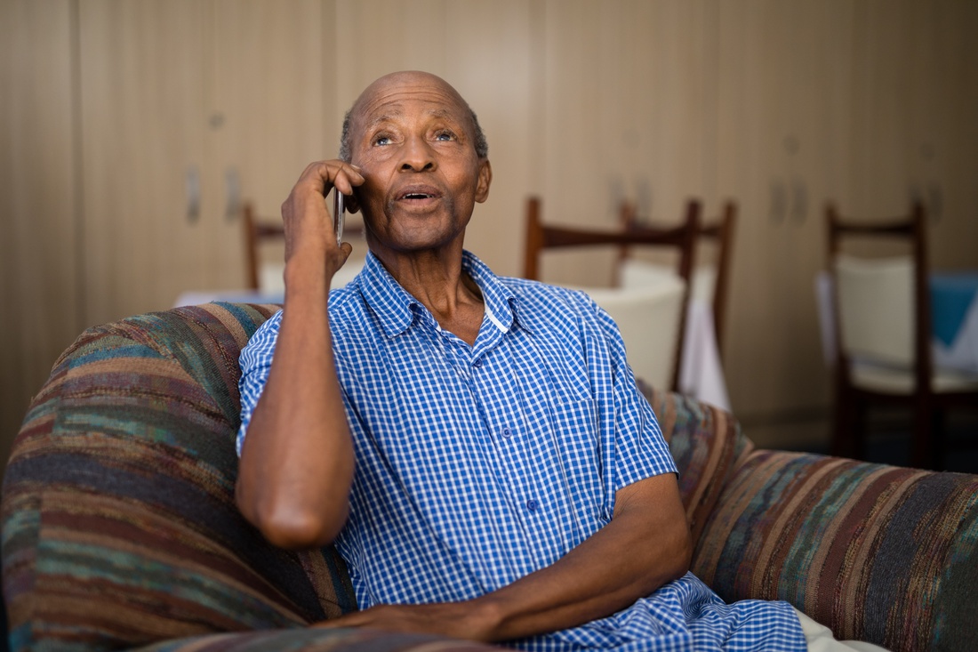 elder African American man on the phone
